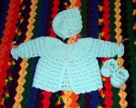 Layette for JoAnn & Erich's baby (shown on top of my favorite rainbow couch blanket, for contrast)