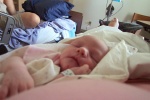 Annabel laying next to her mommy in bed