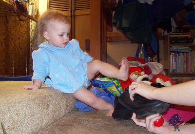 Annabel lifting up her leg to put on Aunt Bub's shoe