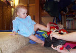 Annabel lifting up her leg to put on Aunt Bub's shoe