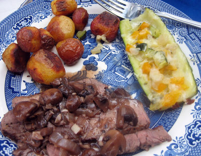 London broil with mushroom sauce, roasted red potatos and stuffed zucchini