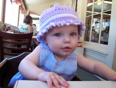 Annabel sitting in a high-chair at the Old P.O.