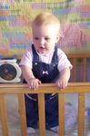 Annabel standing up in the crib