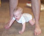 Crawling under Daddy's legs & laughing!