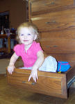 Playing in a kitchen drawer