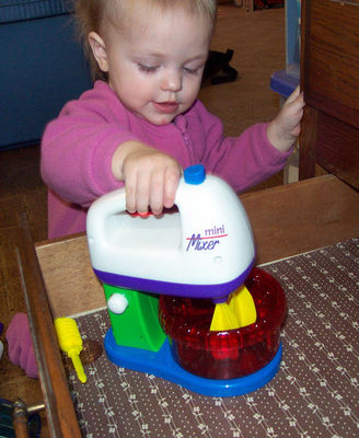 Annabel playing with her new mini-mixer set (#2)