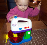 Annabel playing with her new mini-mixer set (#4)