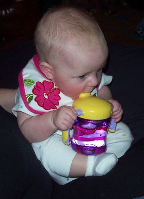 Annabel attacking the sippy cup!