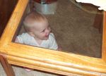 Annabel crawling under the end table