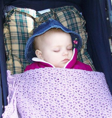 Annabel sleeping snuggly in the stroller