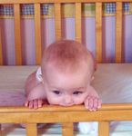 Annabel chewing on the crib rail