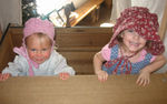 Maia and Annabel playing peek-a-boo in the covered wagon