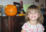 Annabel posing with her carved pumpkin