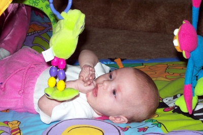 Annabel playing with Mr. Frog on the playmat