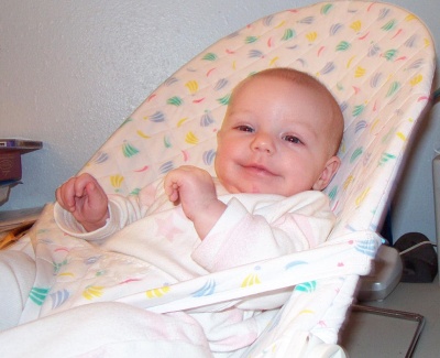 Annabel smiling at Mommy in the bouncy chair