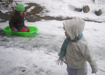 Rebecca & Annabel sledding in the driveway