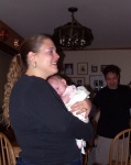 Jula holding Annabel in our dining room with Tony in the background