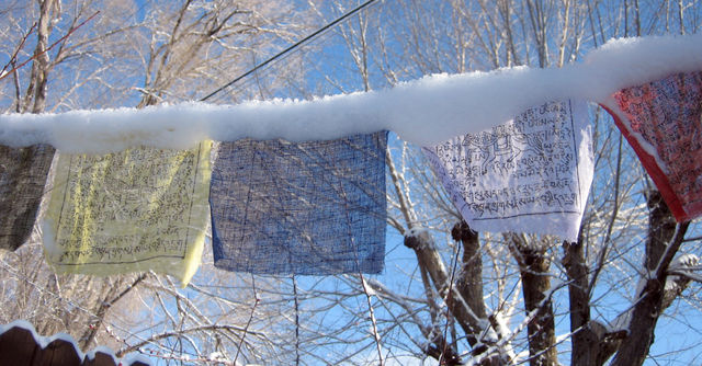 Prayer flags covered in snow