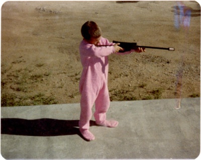 Harold in his pink jammies with his new BB Gun!