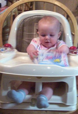 Annabel playing in her new high chair from Great-Grandpa Peters