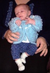 Annabel on Mommy's lap, wearing a beautiful sweater from our friend Joann in Texas