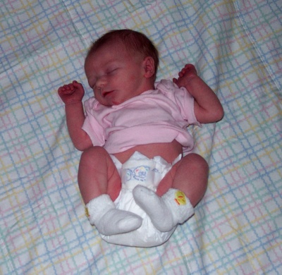 Annabel sleeping on a beautiful quilt made by her great-Aunt Betty in Minnesota